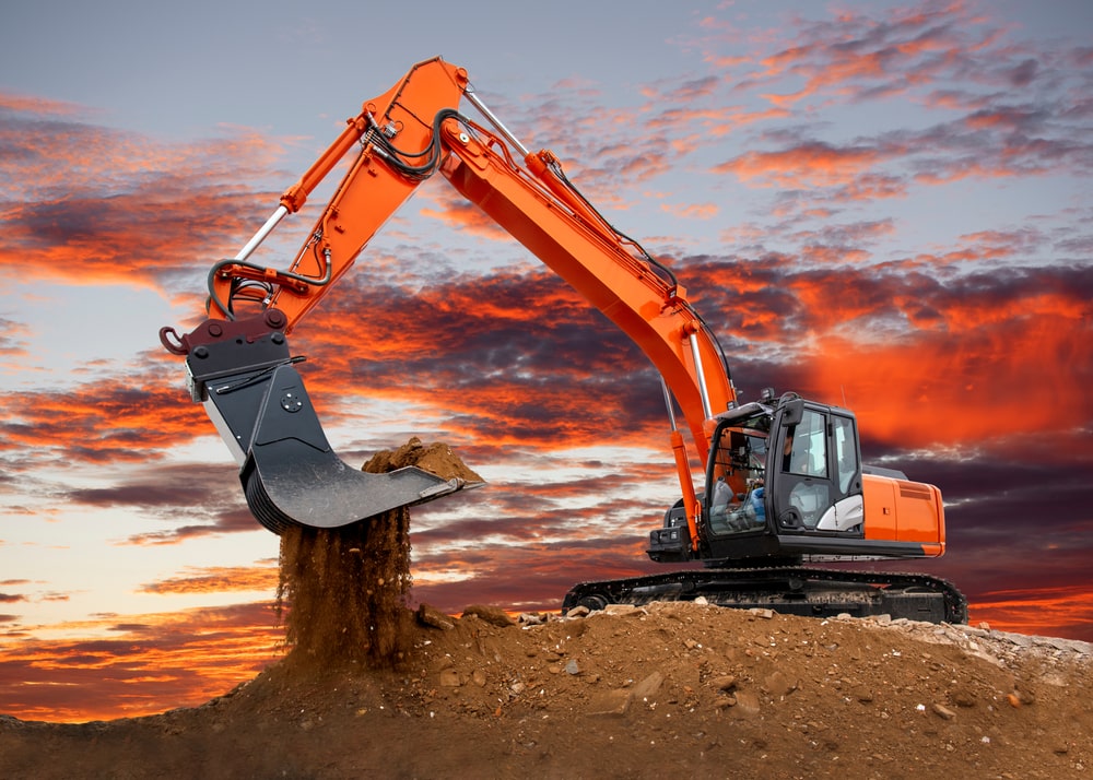 Image of a large orange excavator digging dirt